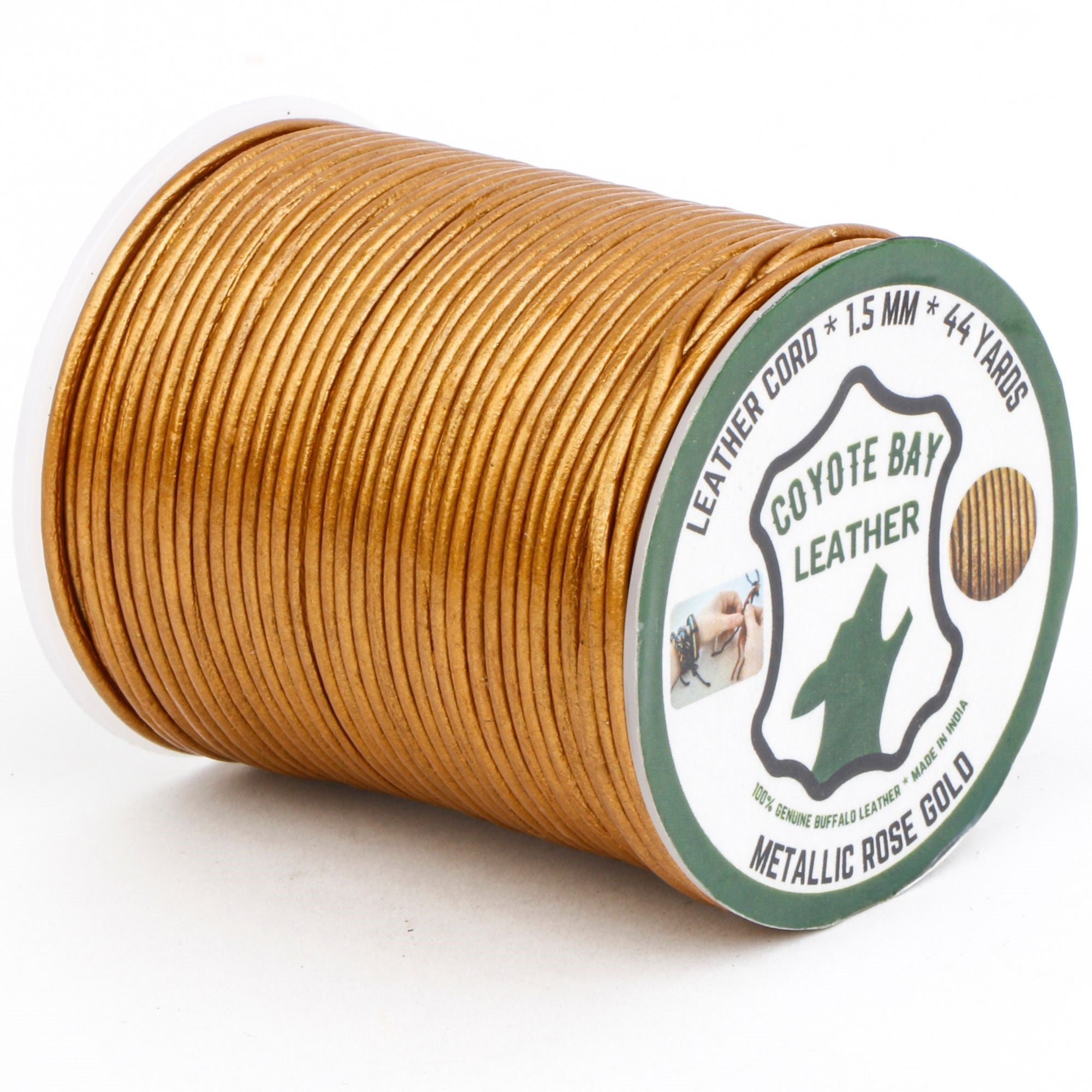 Spool of Coyote Bay Leather cord with metallic rose gold color on a white background